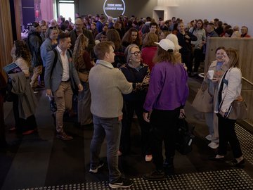 Crowd of people at a networking event or conference.