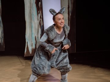 A young woman dressed as a kangaroo, smiling.