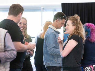 Attendees chatting and networking at a touring workshop
