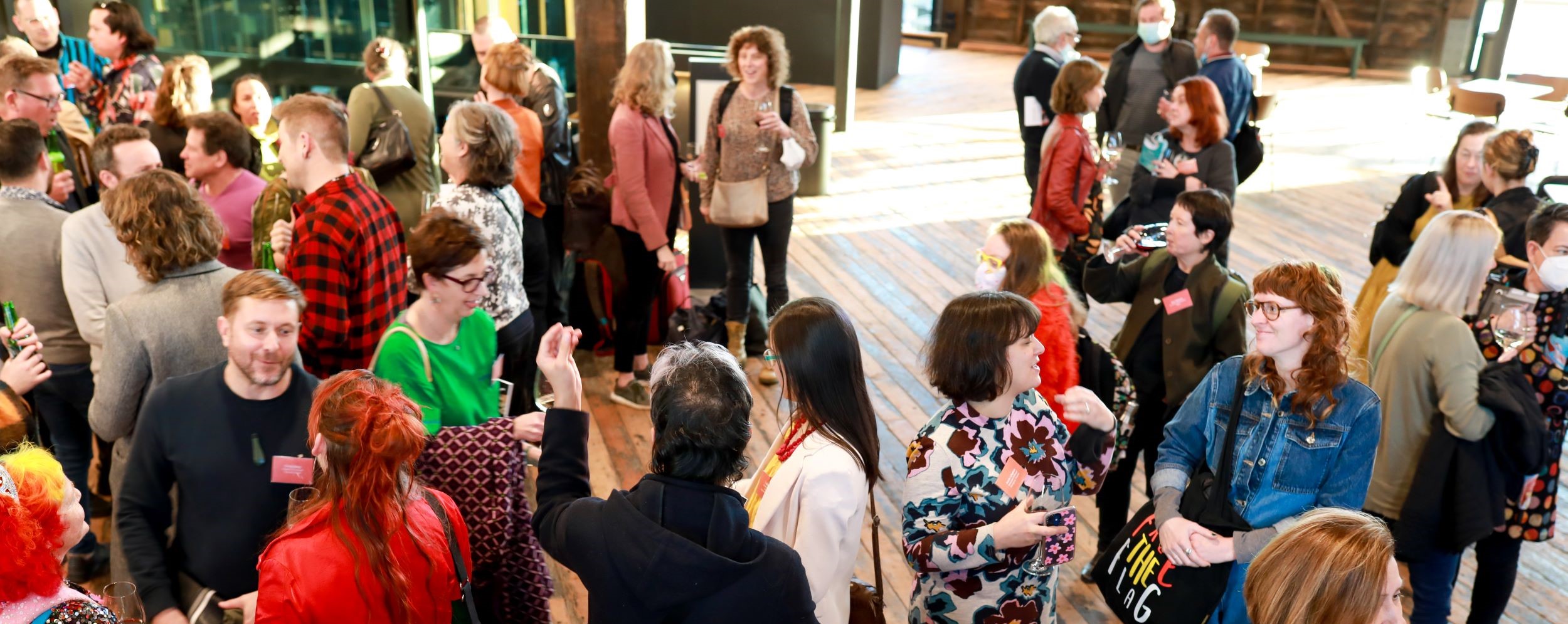 Attendees of Salon 2022 talking in the foyer 